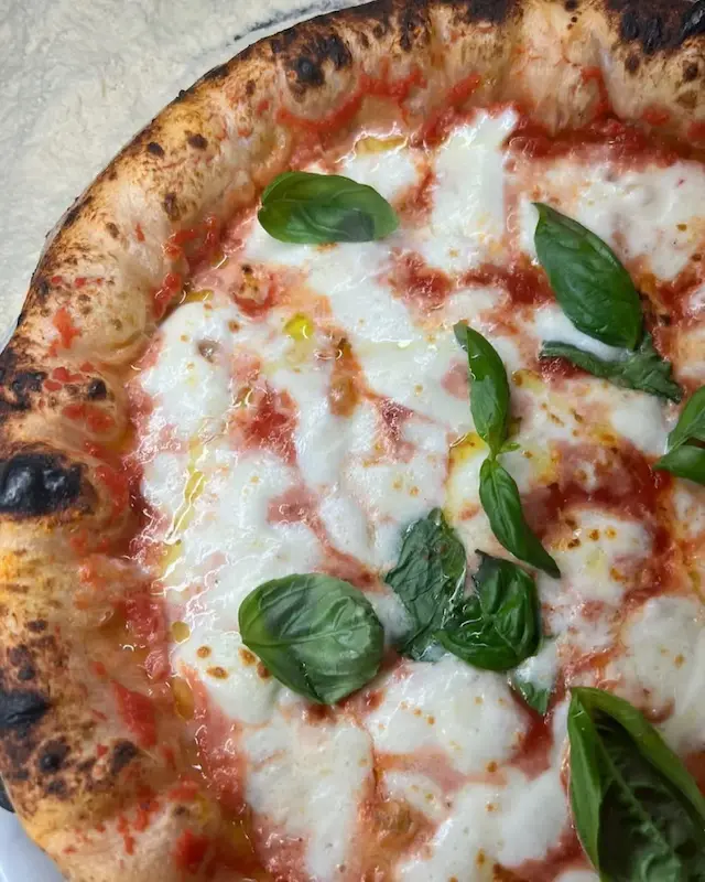 Freshly baked Neapolitan-style pizza during a cooking class in Montepulciano