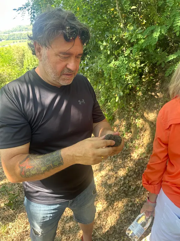 Fabrizio examining a freshly found truffle during a truffle hunting experience in Val d'Orcia