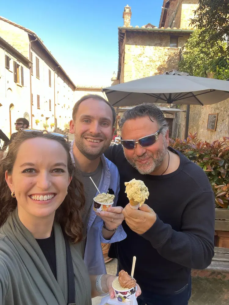 Fabrizio with smiling guests enjoying gelato during a private tour in Tuscany