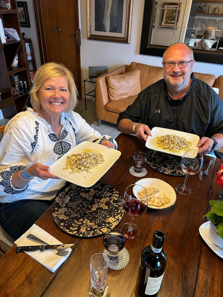 Guests enjoying a homemade Tuscan dinner with wine at Fabrizio's home in Montepulciano