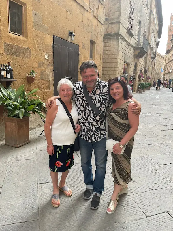 Happy guests with their local tour guide during a private tour in a historic Tuscan hill town